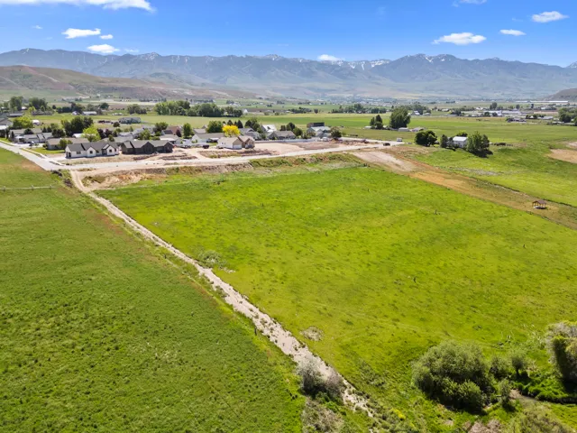 Expansive green field with a natural waterway bordering the property