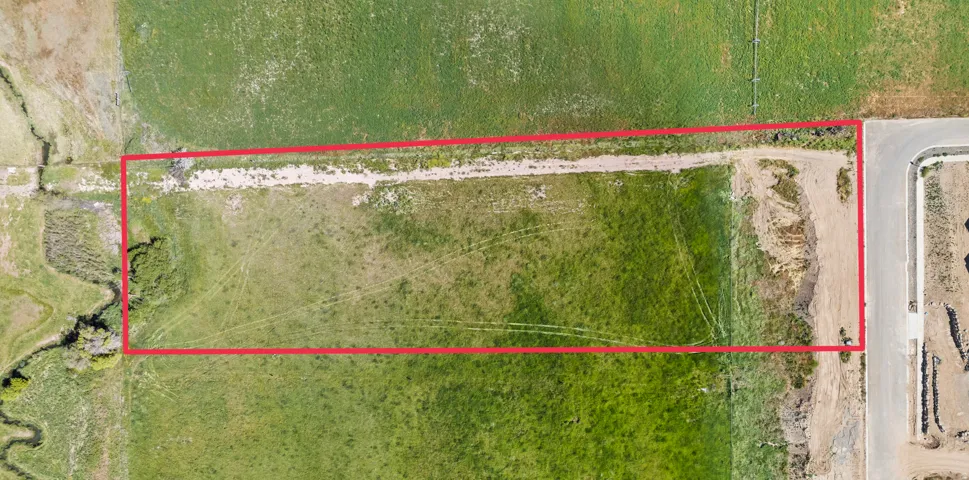 Expansive rectangular land parcel featuring a visible boundary
