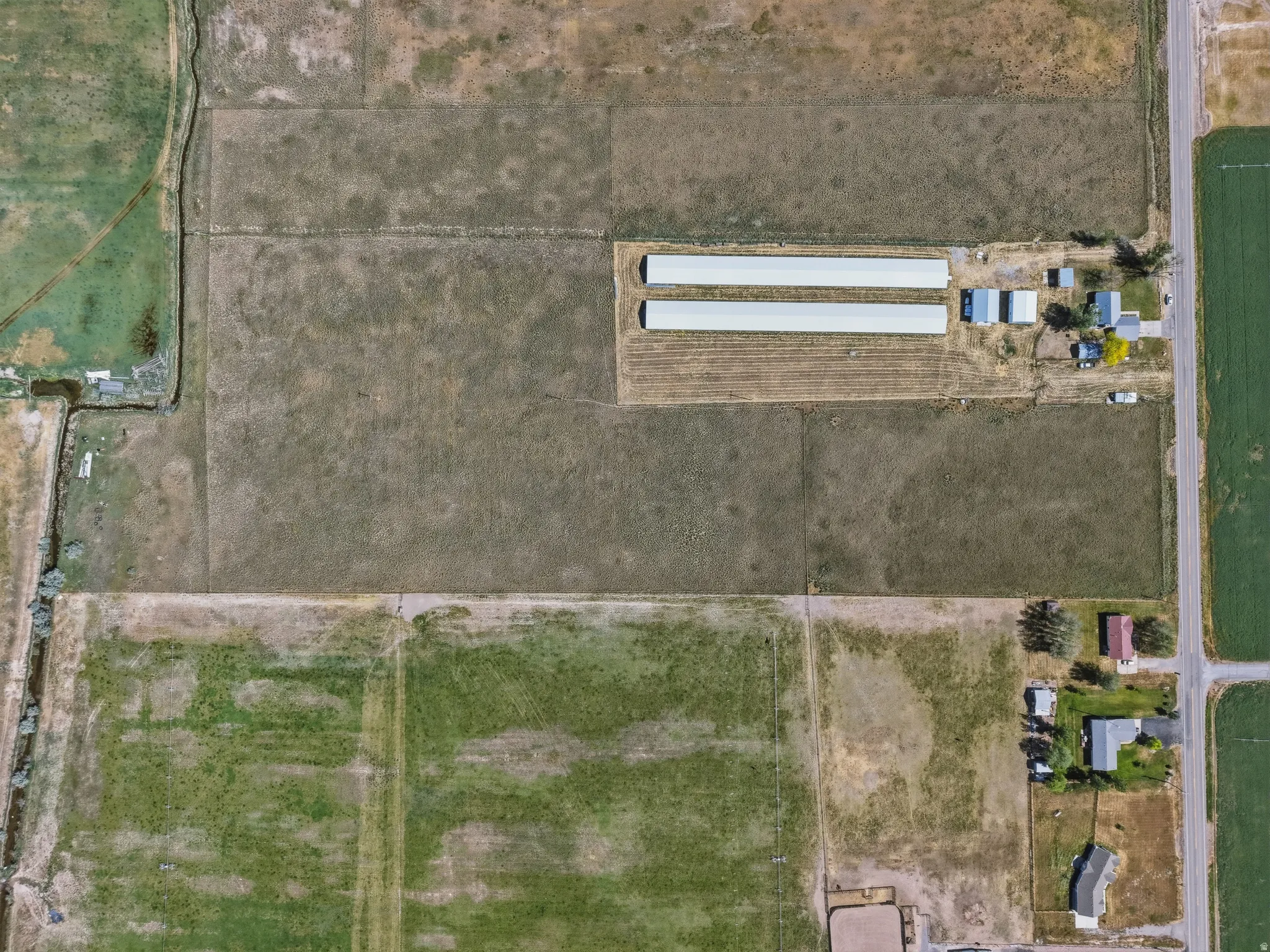 Aerial Photograph. Displaying the property's layout, structures, and surrounding land parcels