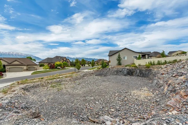 Excavated building pad featuring exposed rock, gravel, and a level surface