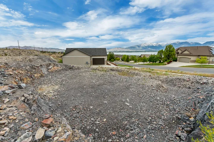 Rocky terrain lot with distant mountain and body of water scenery
