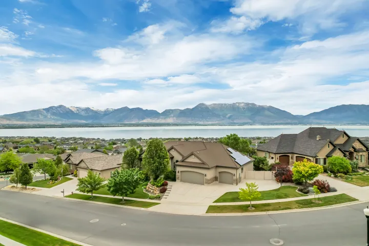 Aerial perspective showcasing a residential street with distant mountains and a body of water