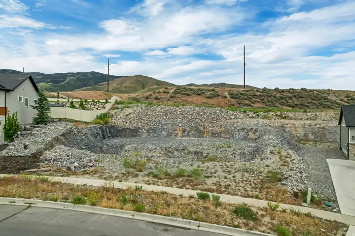 Excavated building lot featuring a level pad and surrounding rock