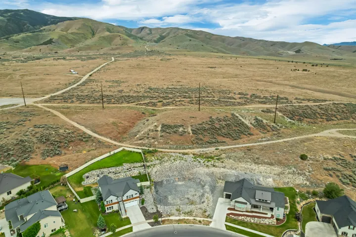 Expansive land parcel featuring natural terrain and distant mountains