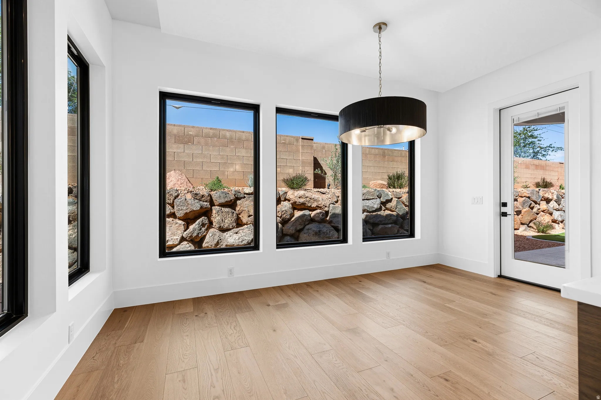 Hardwood-finish flooring complementing white walls and contemporary baseboards