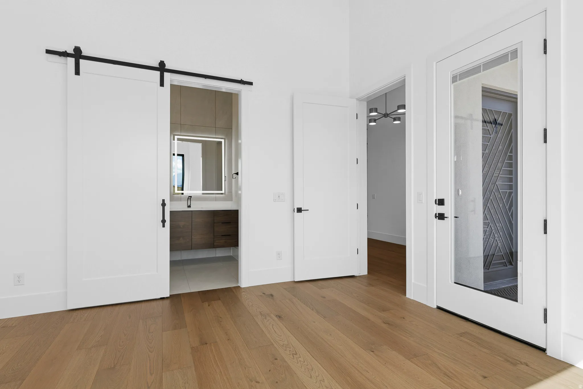 Light wood-finish flooring extending into multiple rooms