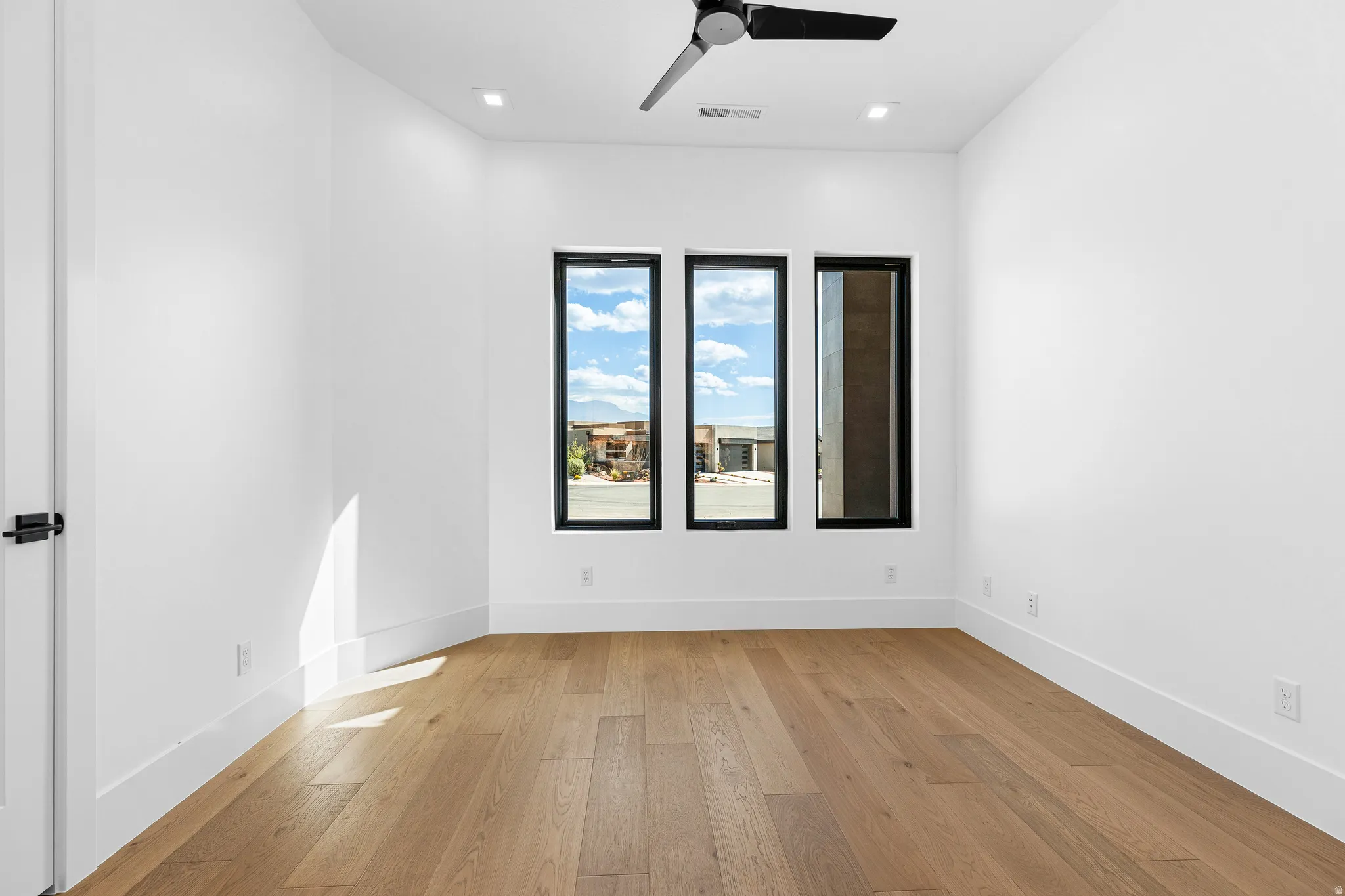 Light wood-finish flooring complements bright white walls and trim