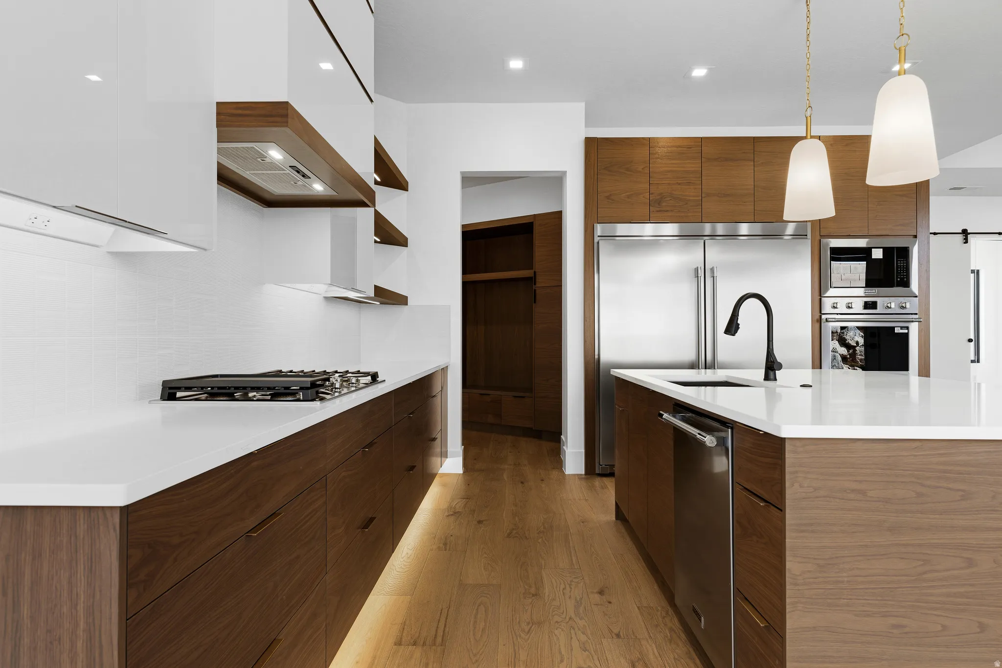 Contemporary kitchen featuring wood-finish cabinetry, light countertops, and light wood-finish flooring