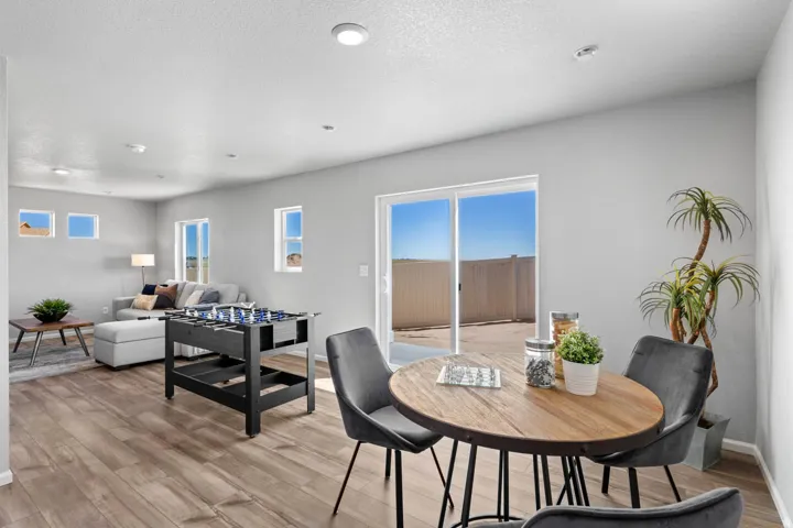 Open-concept living area featuring wood-finish flooring, recessed lighting, and light gray wall tones