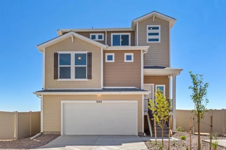 Multi-level exterior featuring tan siding and shake accents