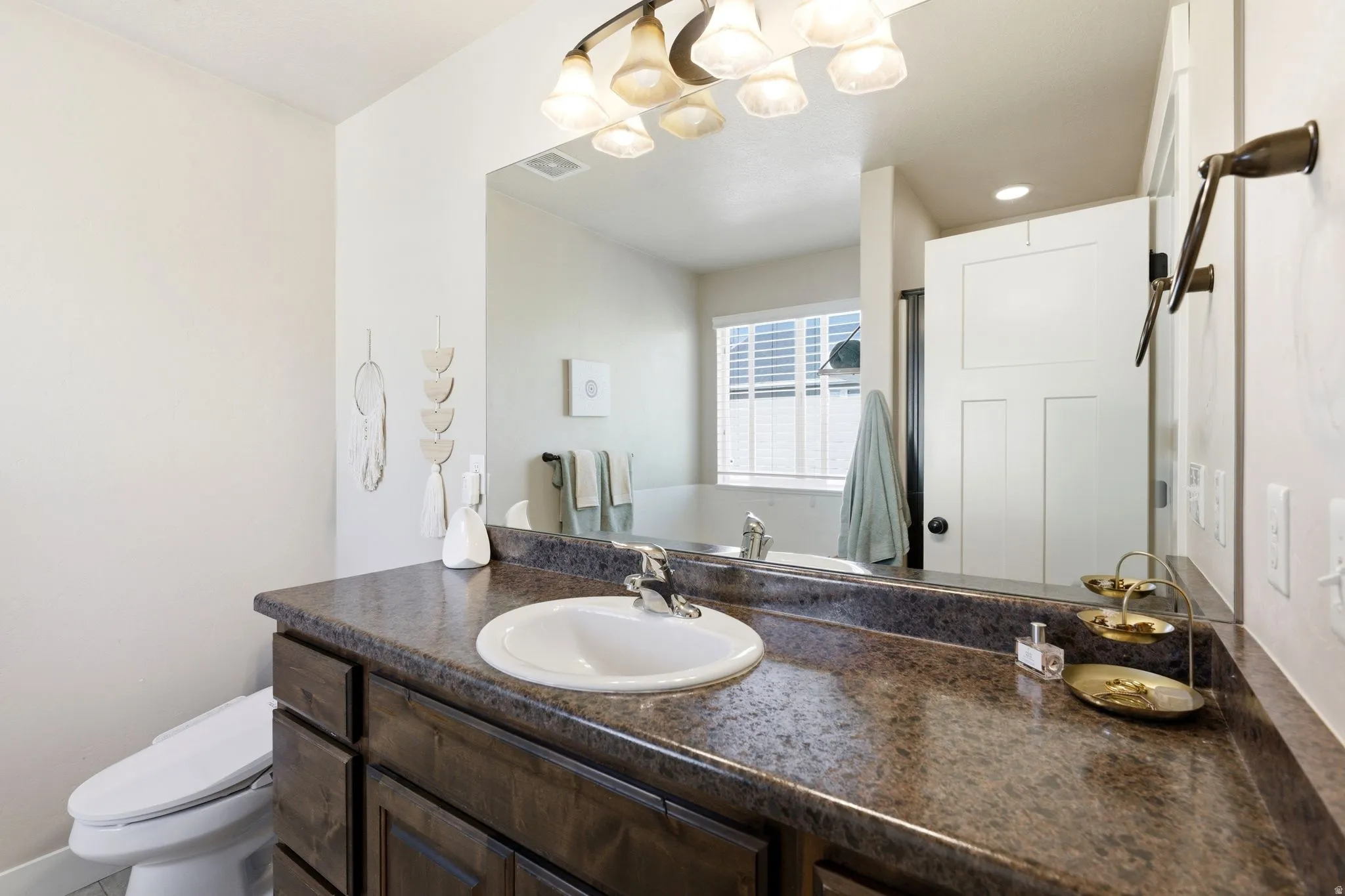 Bathroom vanity with a built-in sink and dark wood-finish cabinetry