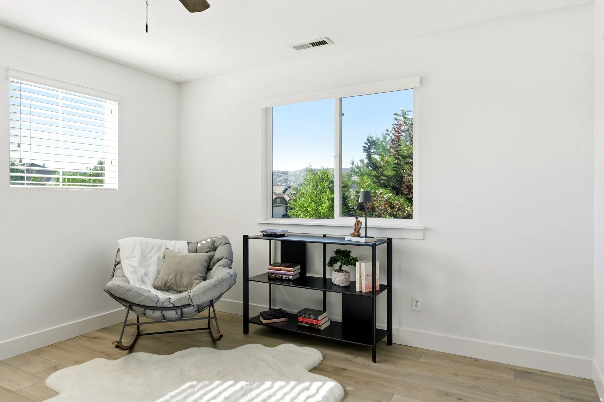 Bright interior space featuring wood-finish flooring and white walls
