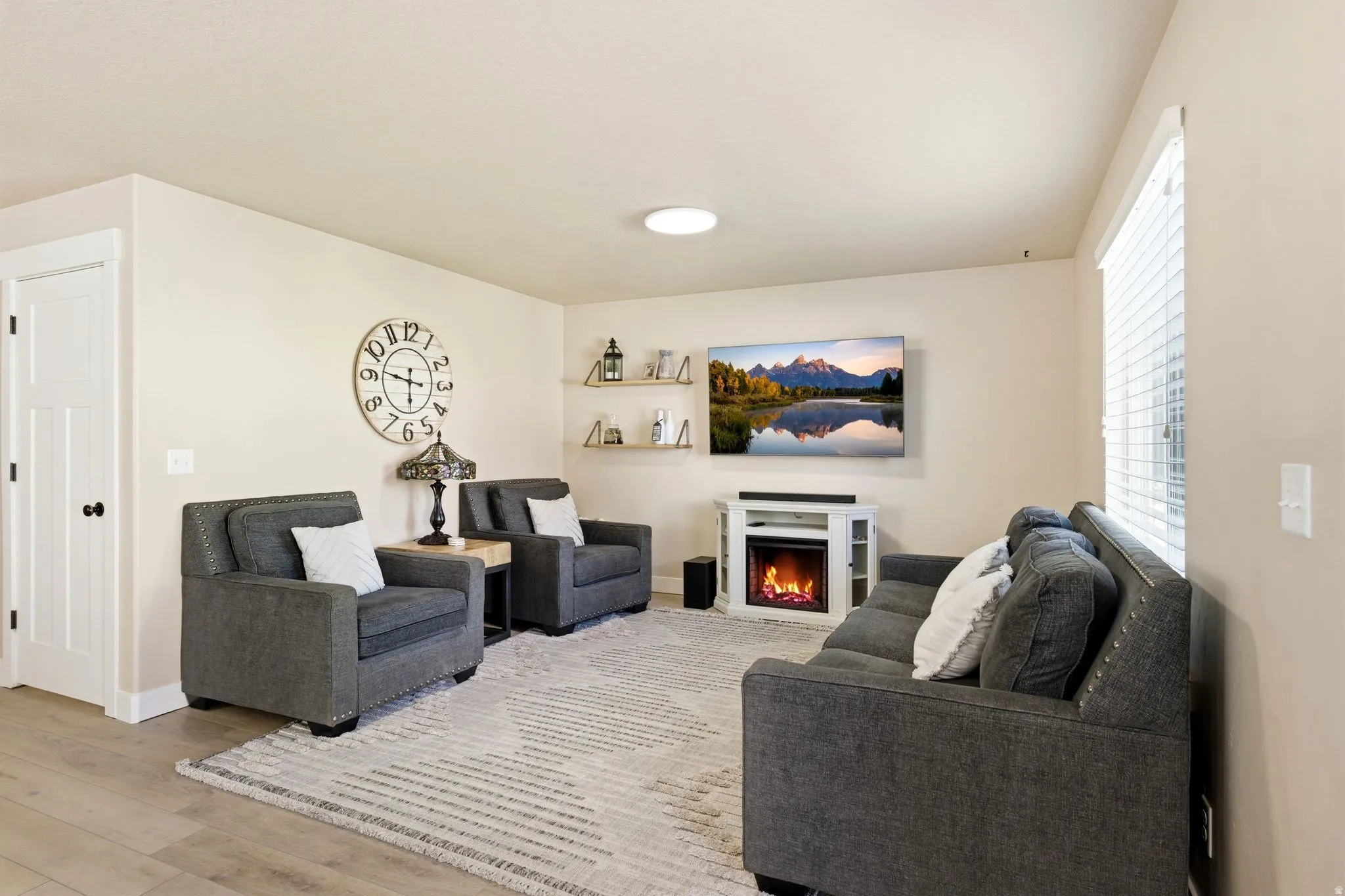 Living area featuring light wood-finish flooring and neutral wall tones