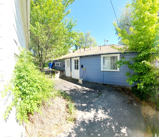 Exterior property featuring blue horizontal siding and a light-colored roof