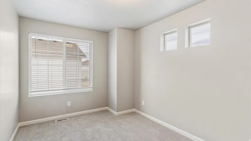 Carpeted interior with light gray walls and white trim