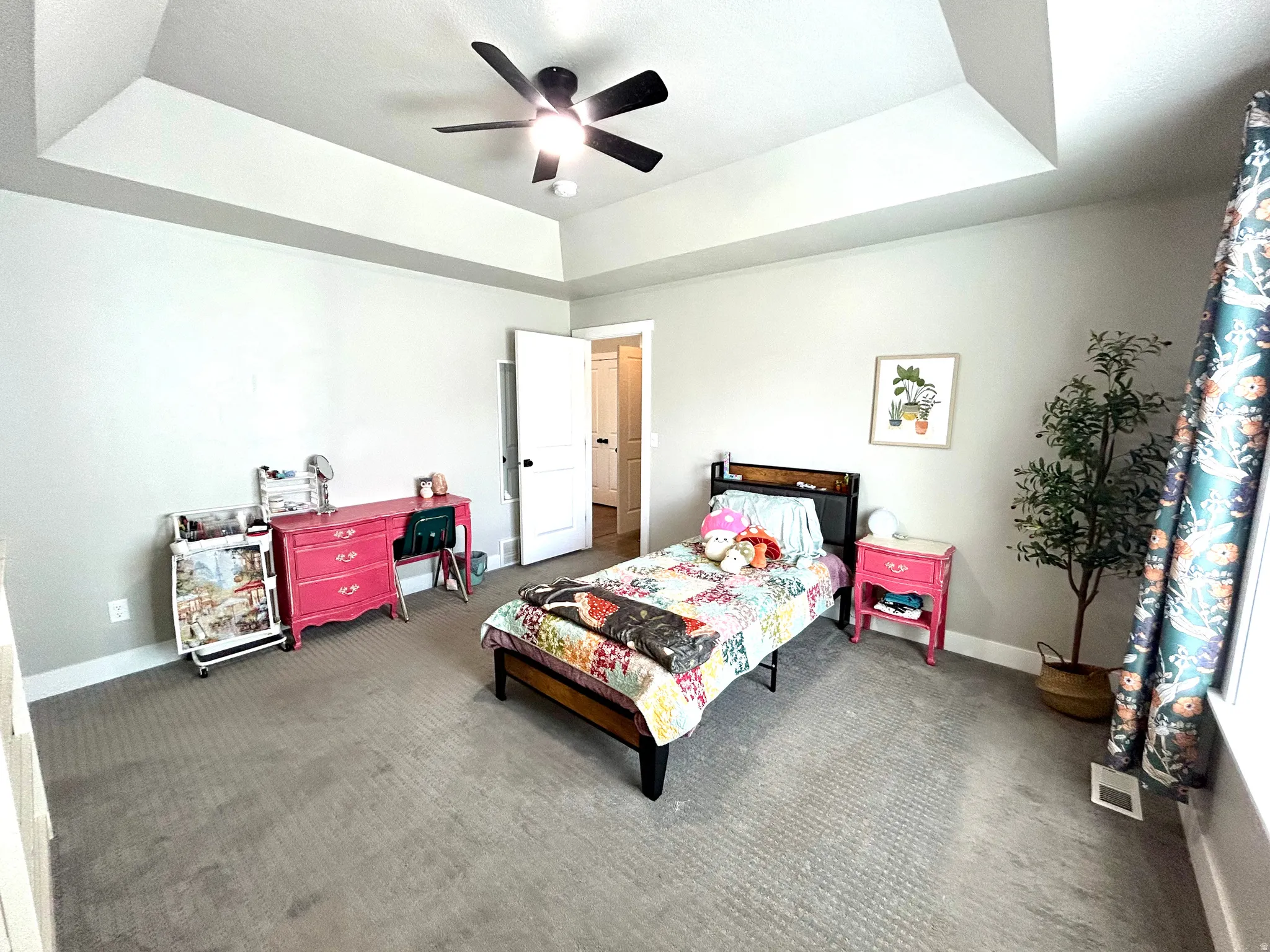 Bedroom featuring tray ceiling, recessed lighting, ceiling fan, neutral wall color, and wall-to-wall carpeting