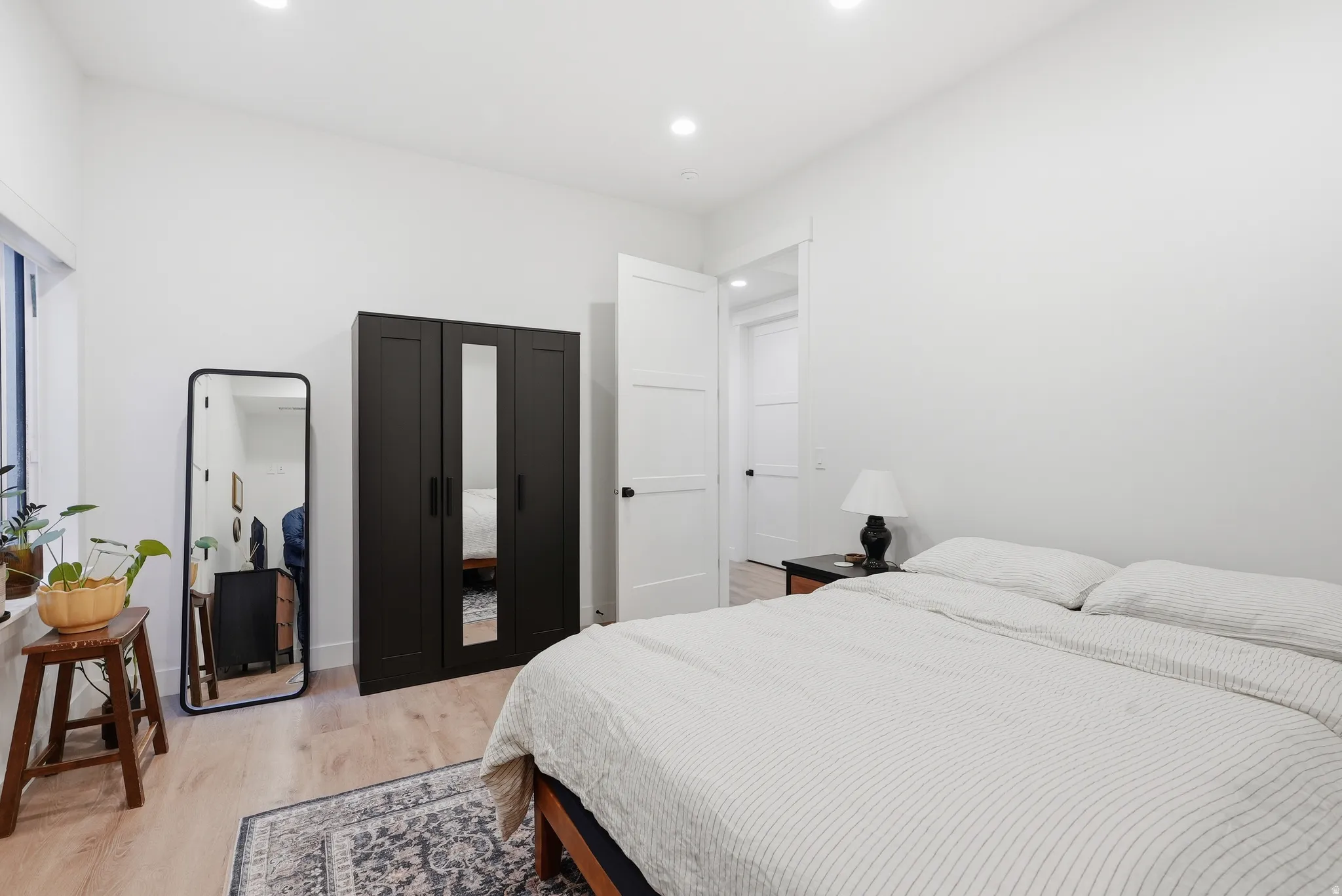 Light LVP flooring complements the bright white walls and recessed ceiling lighting