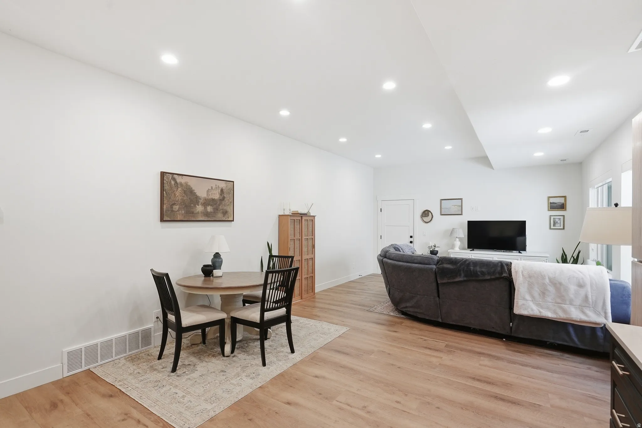Bright interior space featuring LVP flooring, recessed lighting, and white walls