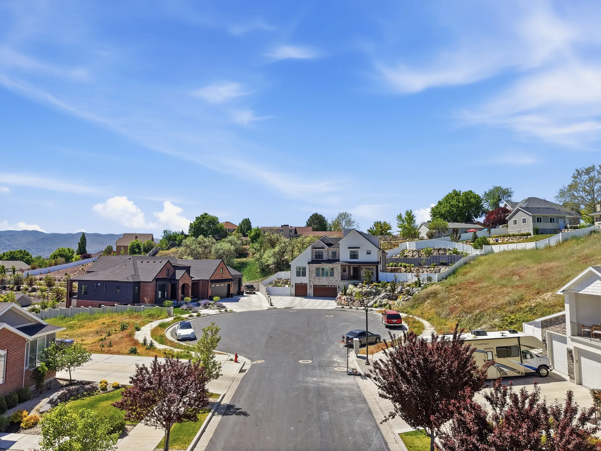 Residential street featuring single-family homes and mountain scenery