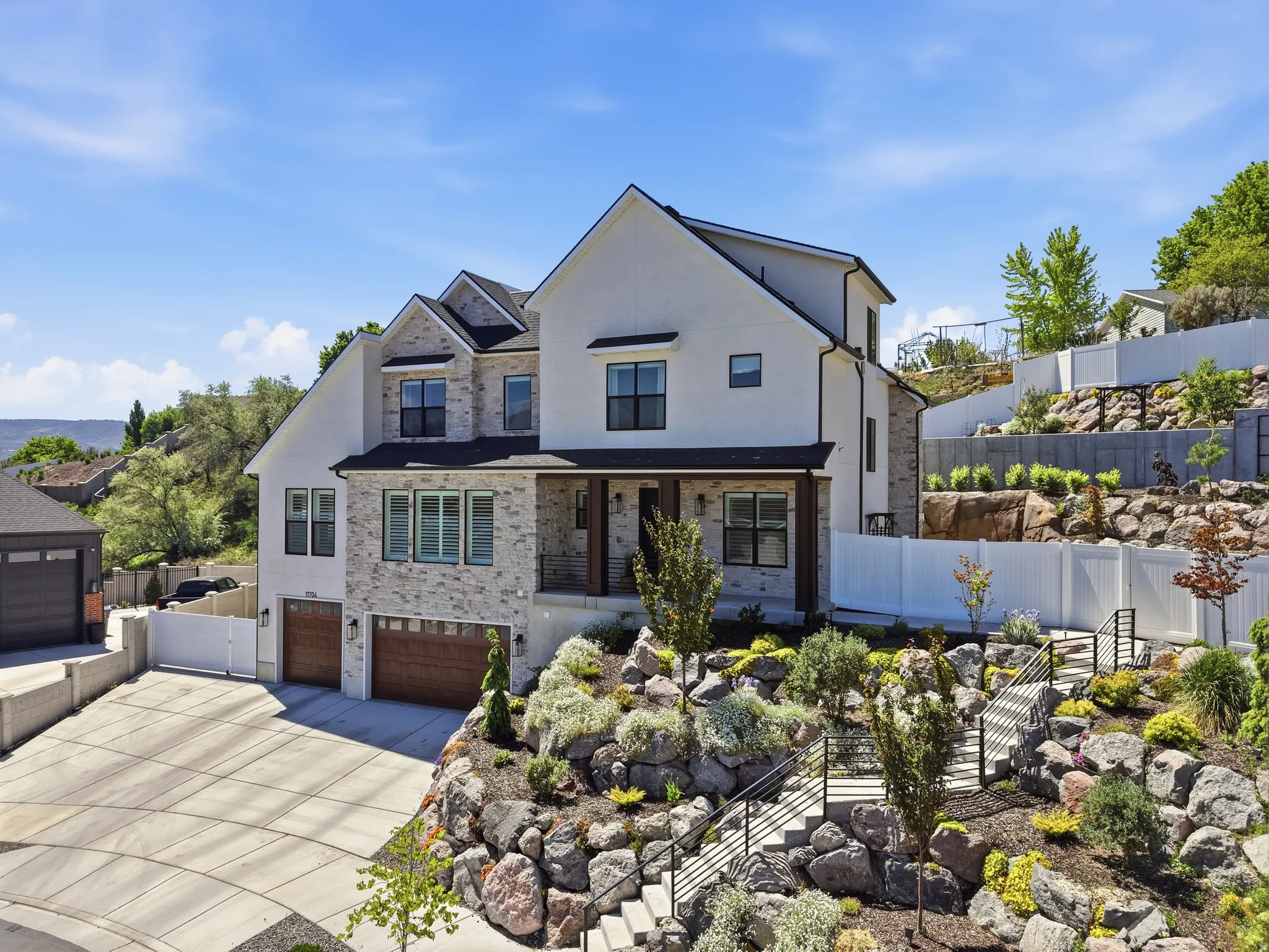 Stately two-story residence featuring a stone and stucco exterior