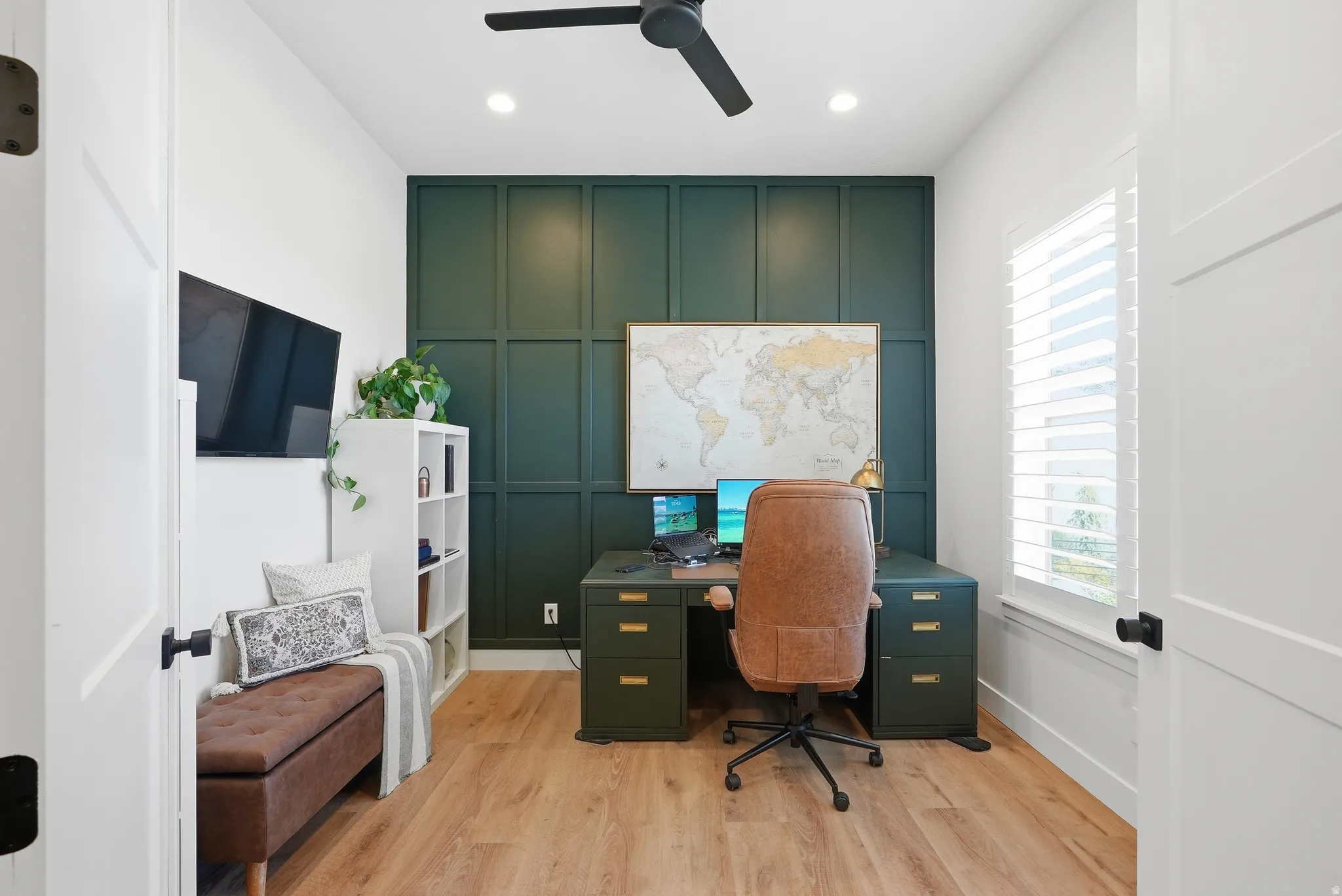 Dedicated room featuring LVP flooring and a prominent accent wall with panel molding