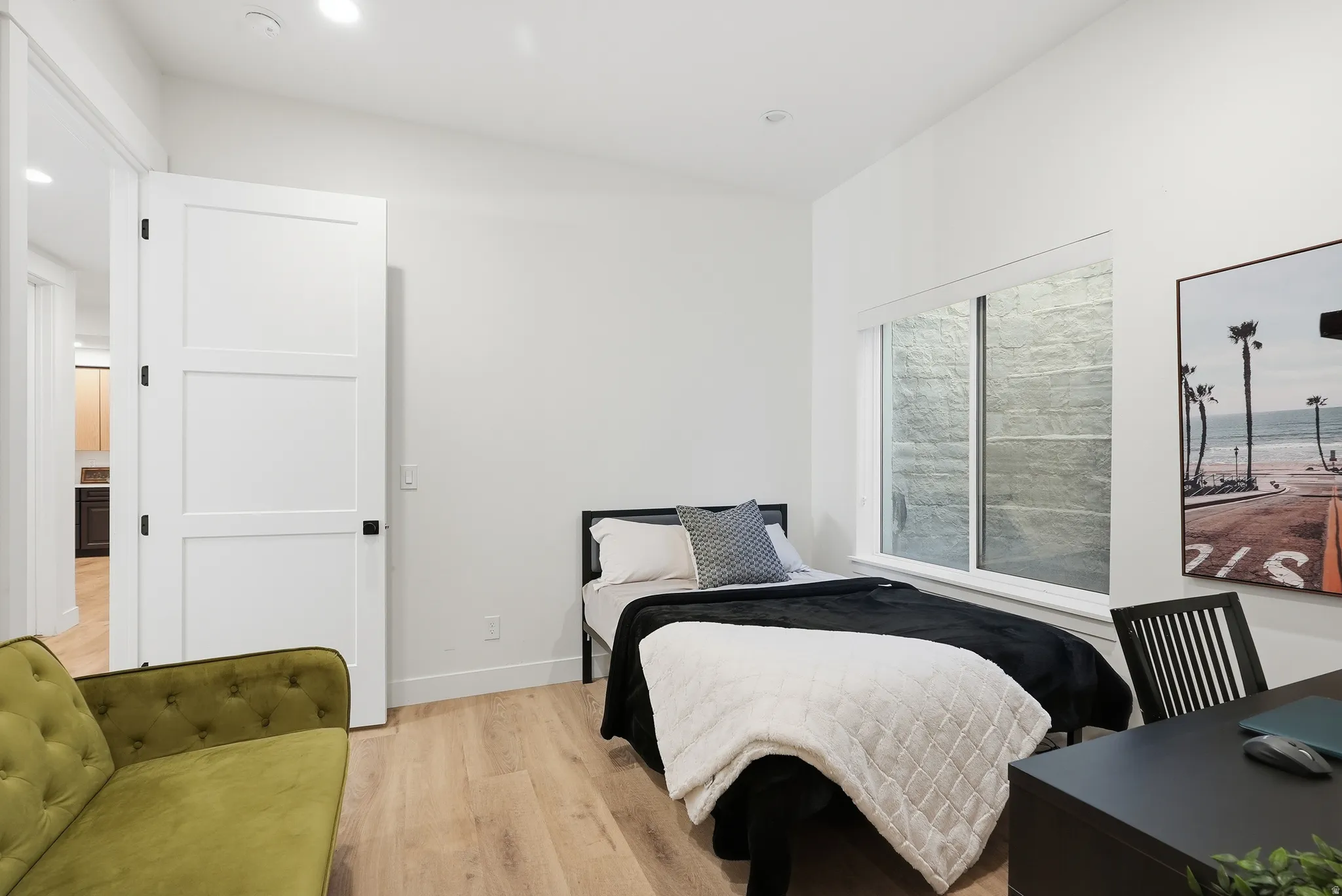 Bright room featuring LVP finish flooring and recessed ceiling lighting