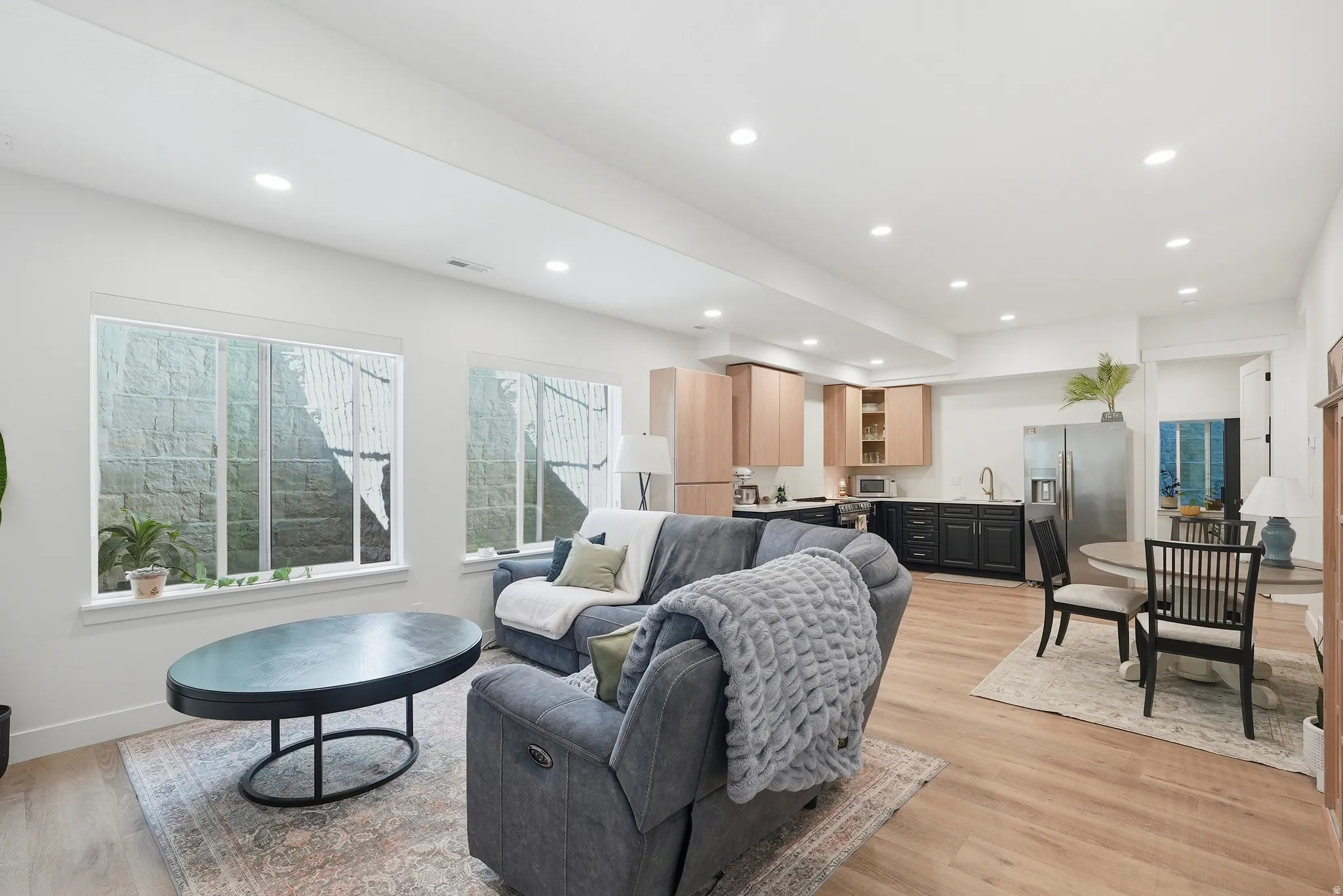 Open-concept living space featuring recessed lighting, LVP flooring, and white walls