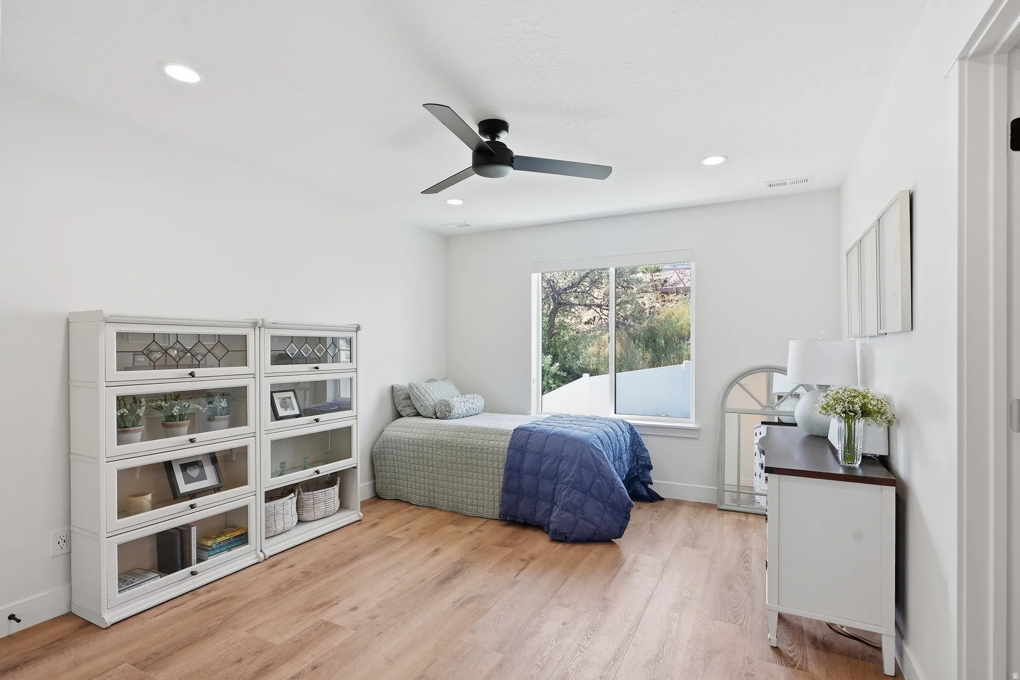 White walls complement LVP flooring in this room featuring a large window