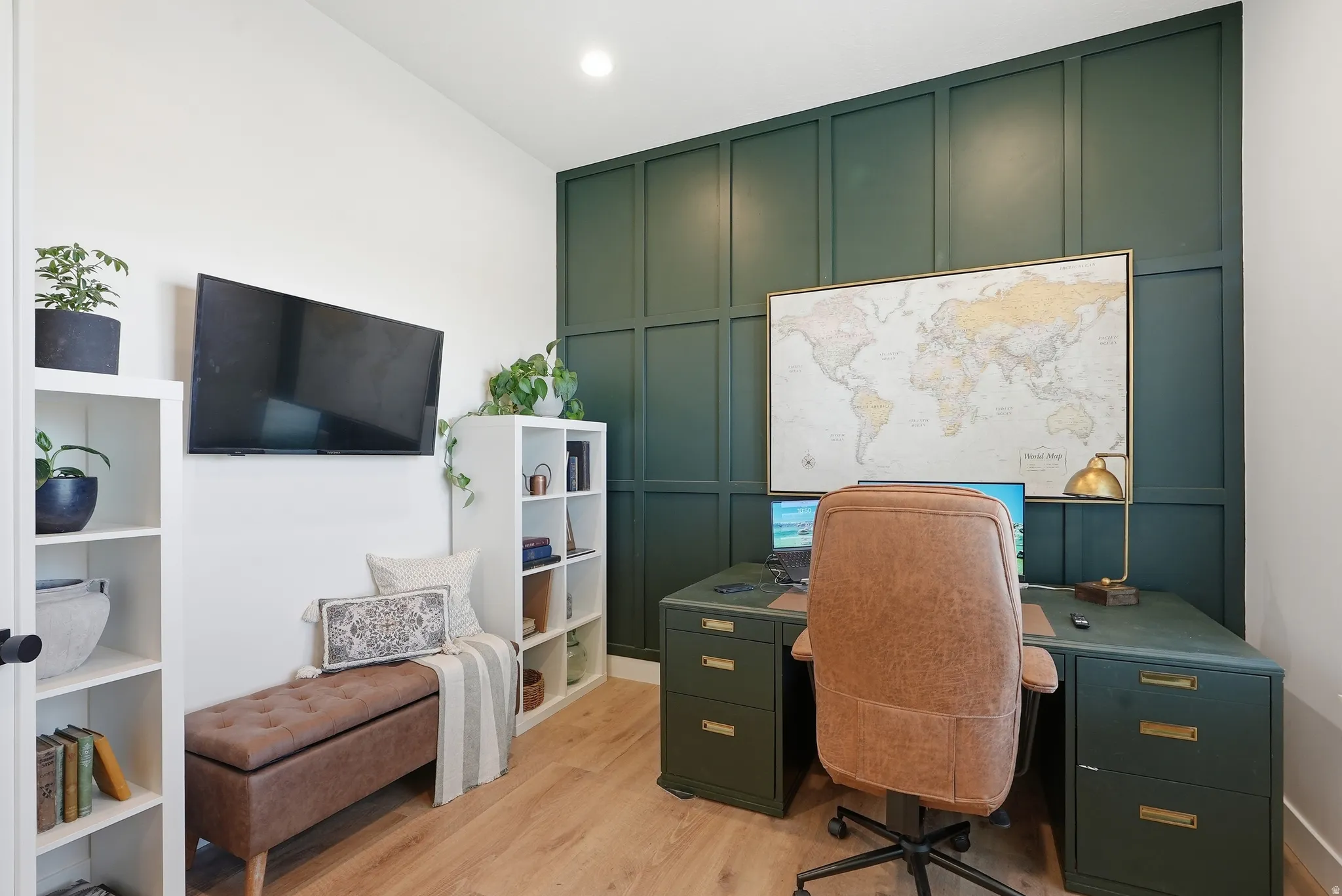 Accent wall featuring dark green wainscoting