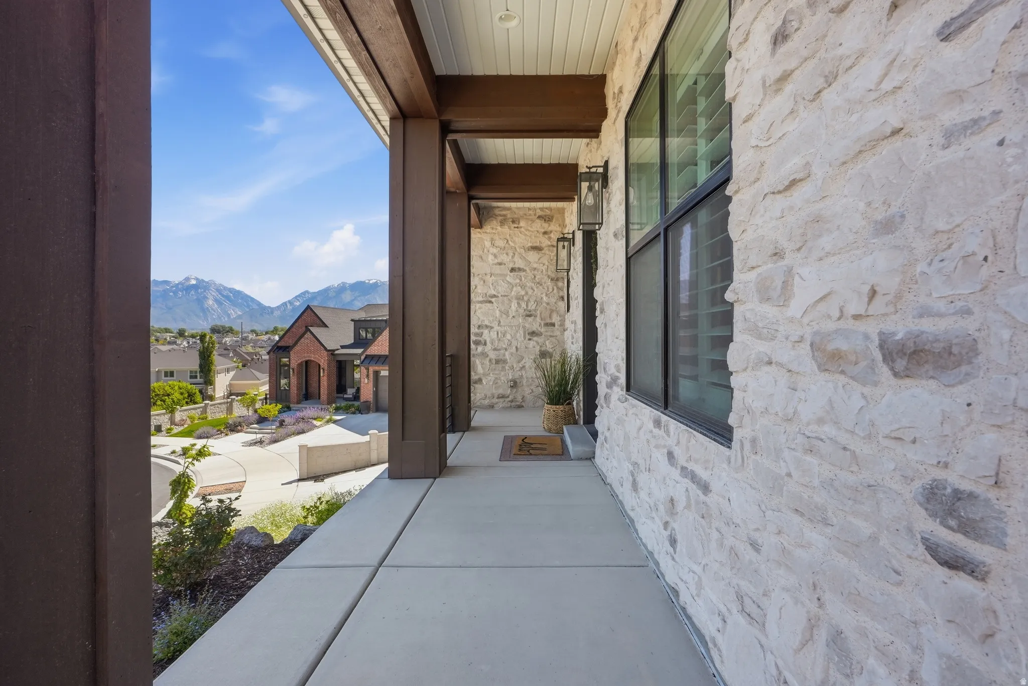 Covered concrete porch with robust wood-finish beams