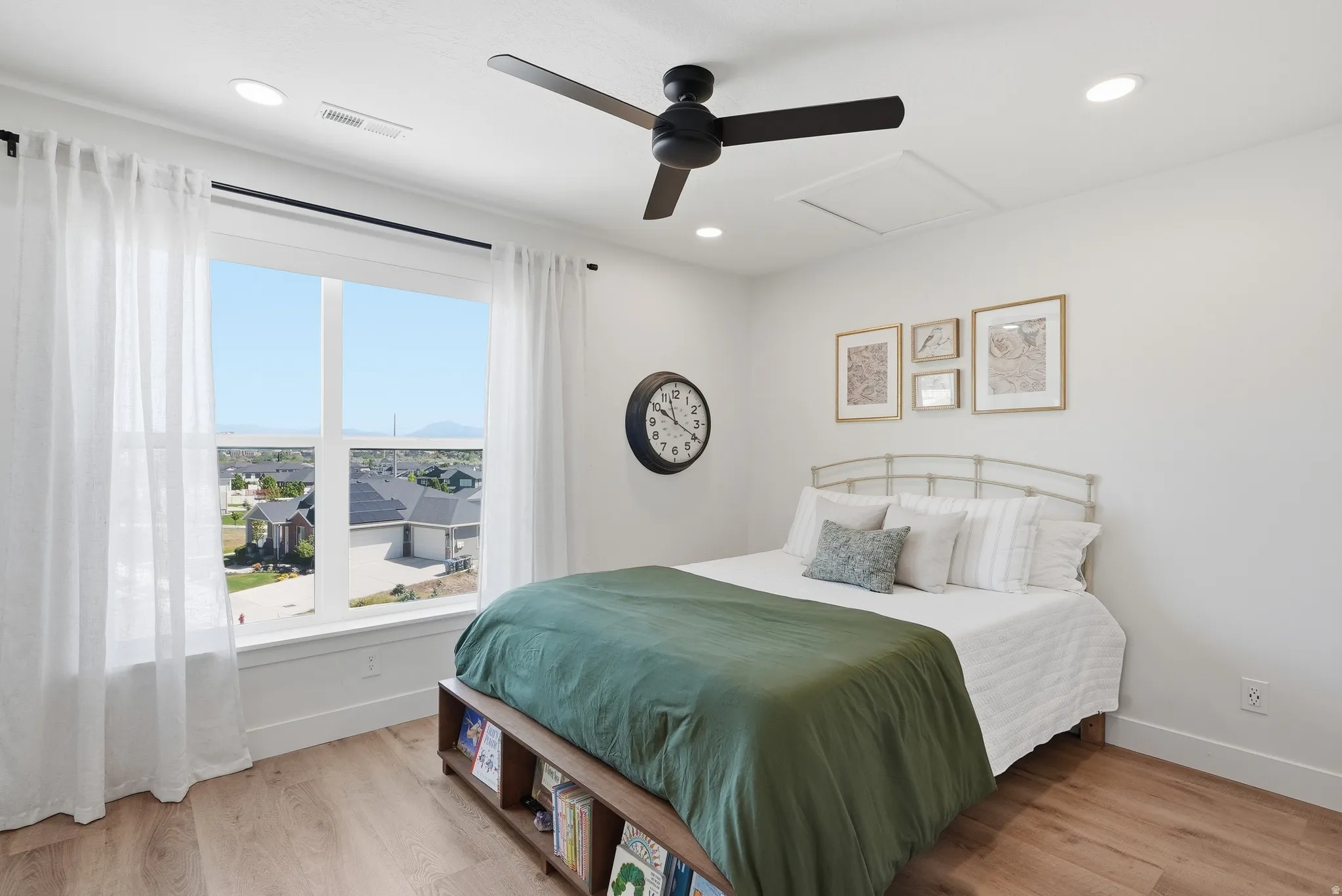 Bright room featuring a large window, a ceiling fan with integrated lighting, recessed ceiling lights, and LVP flooring