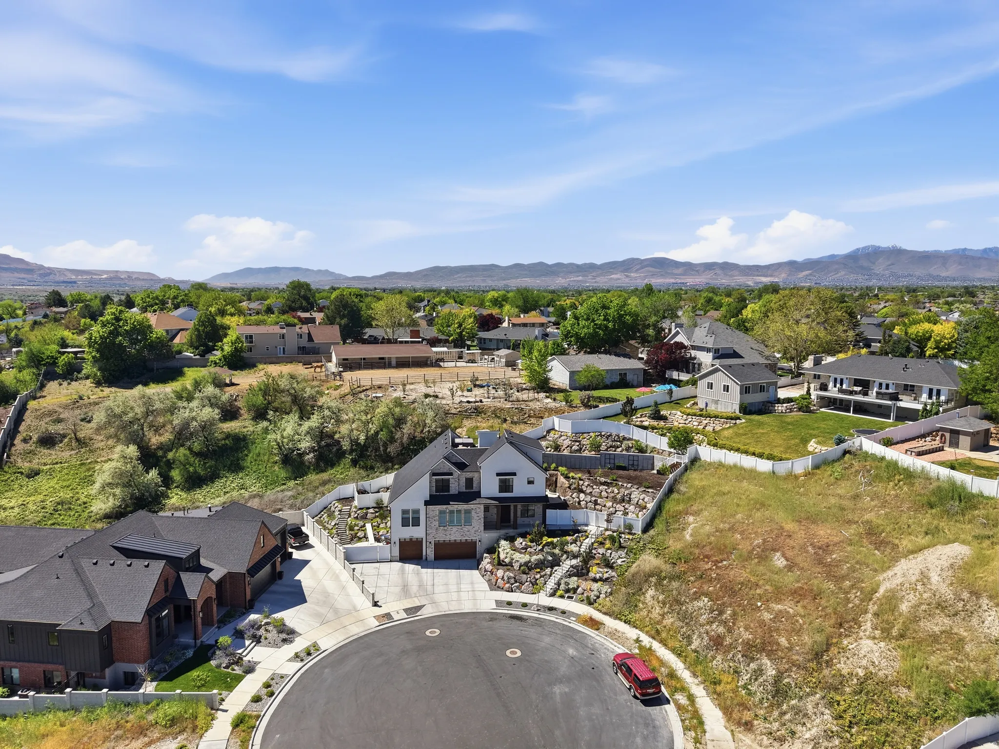Stately two-story residence featuring a stone and stucco exterior
