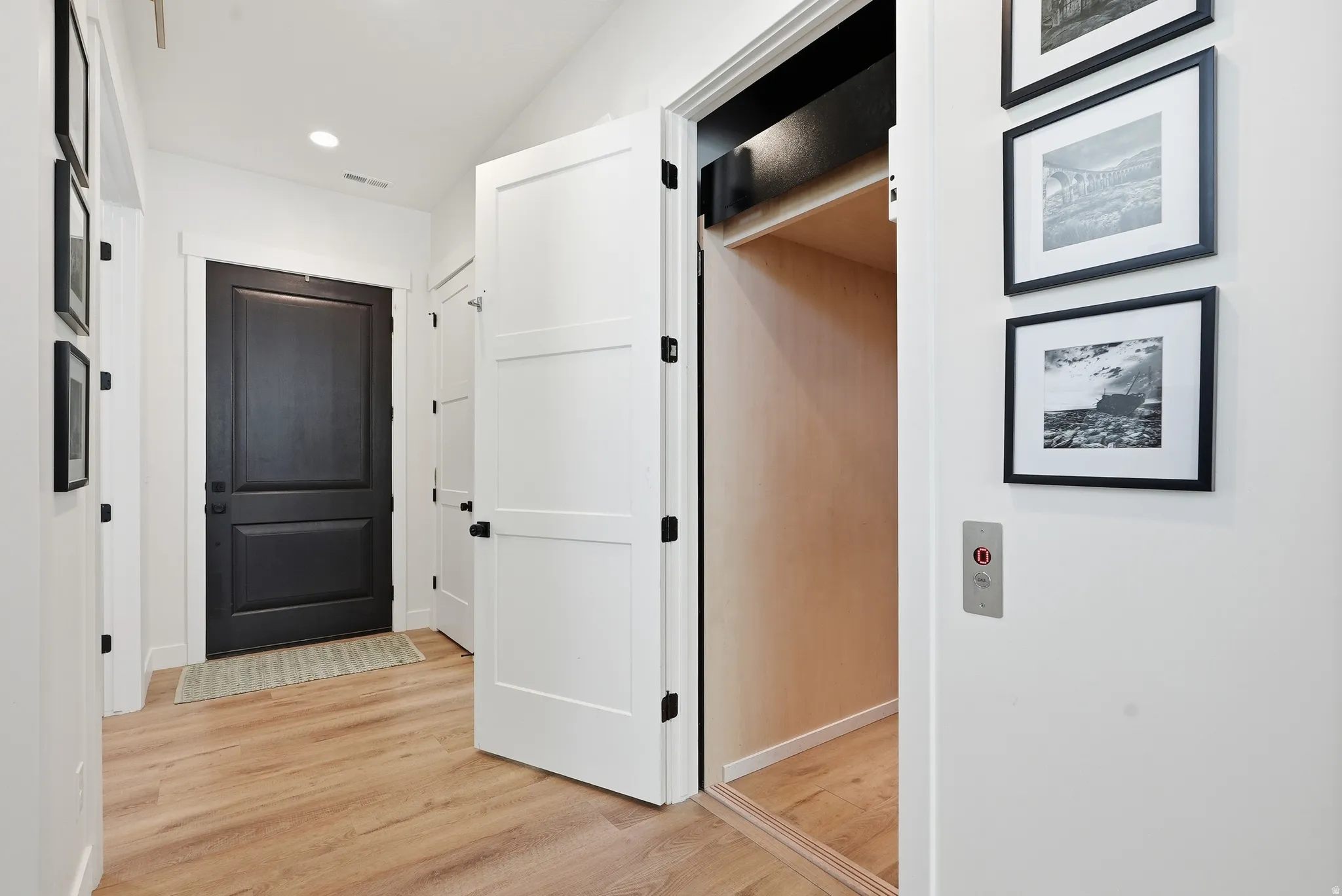 Hallway featuring , recessed lighting, and a dark paneled entry door