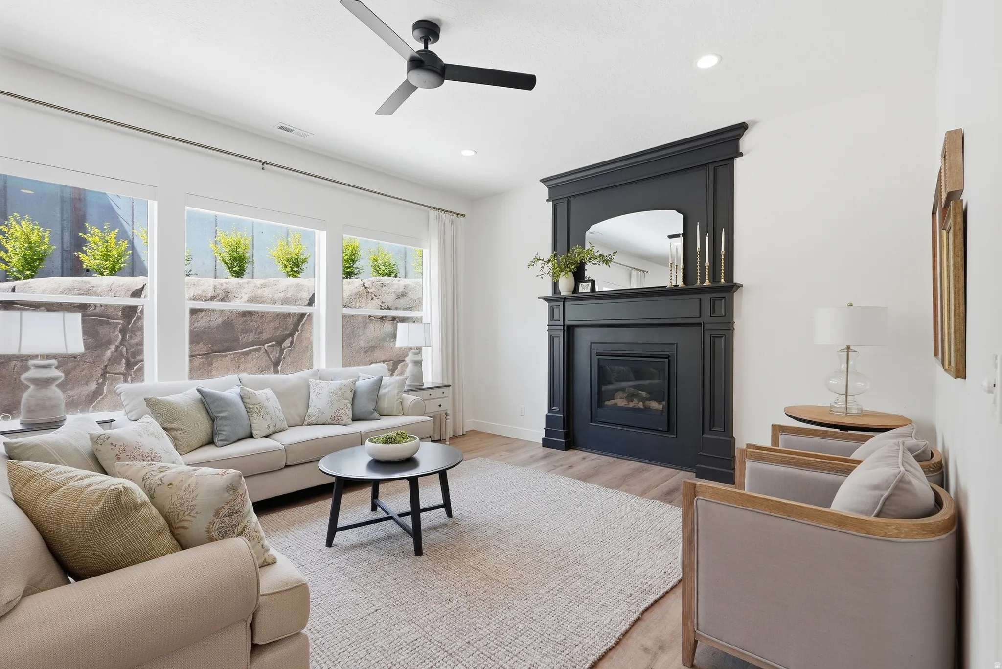 Spacious living area featuring a decorative dark mantel with an embedded fireplace