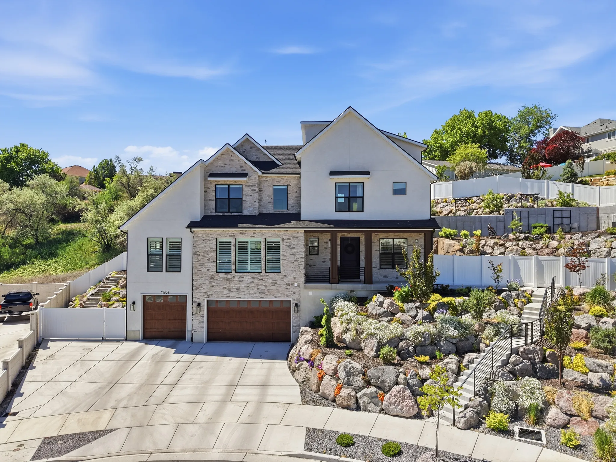 Stately two-story residence featuring a stone and stucco exterior