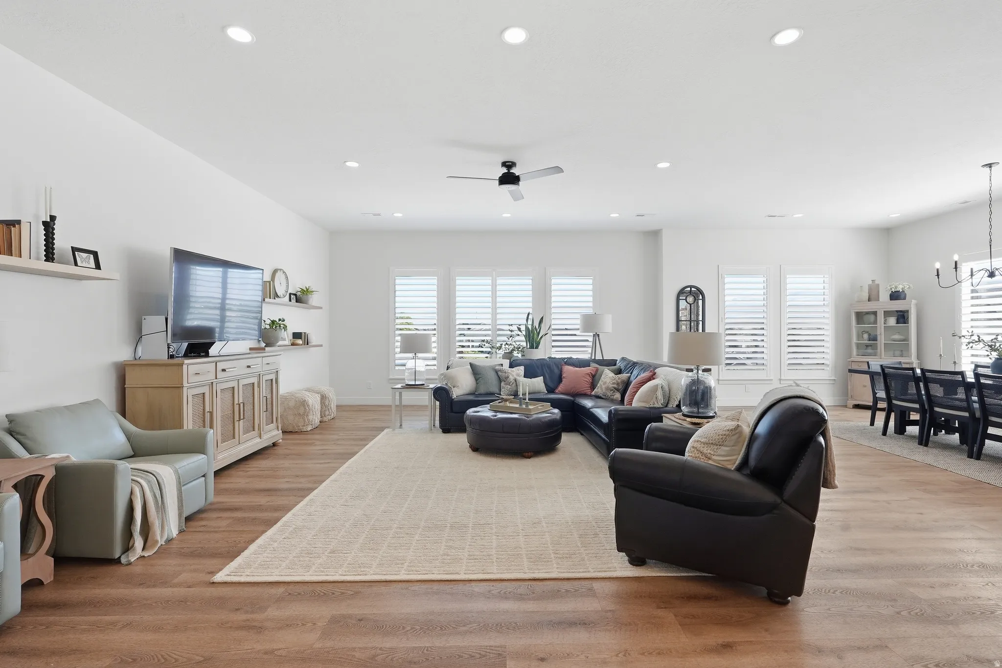 Spacious living area featuring LVP  flooring, recessed lighting, and a ceiling fan