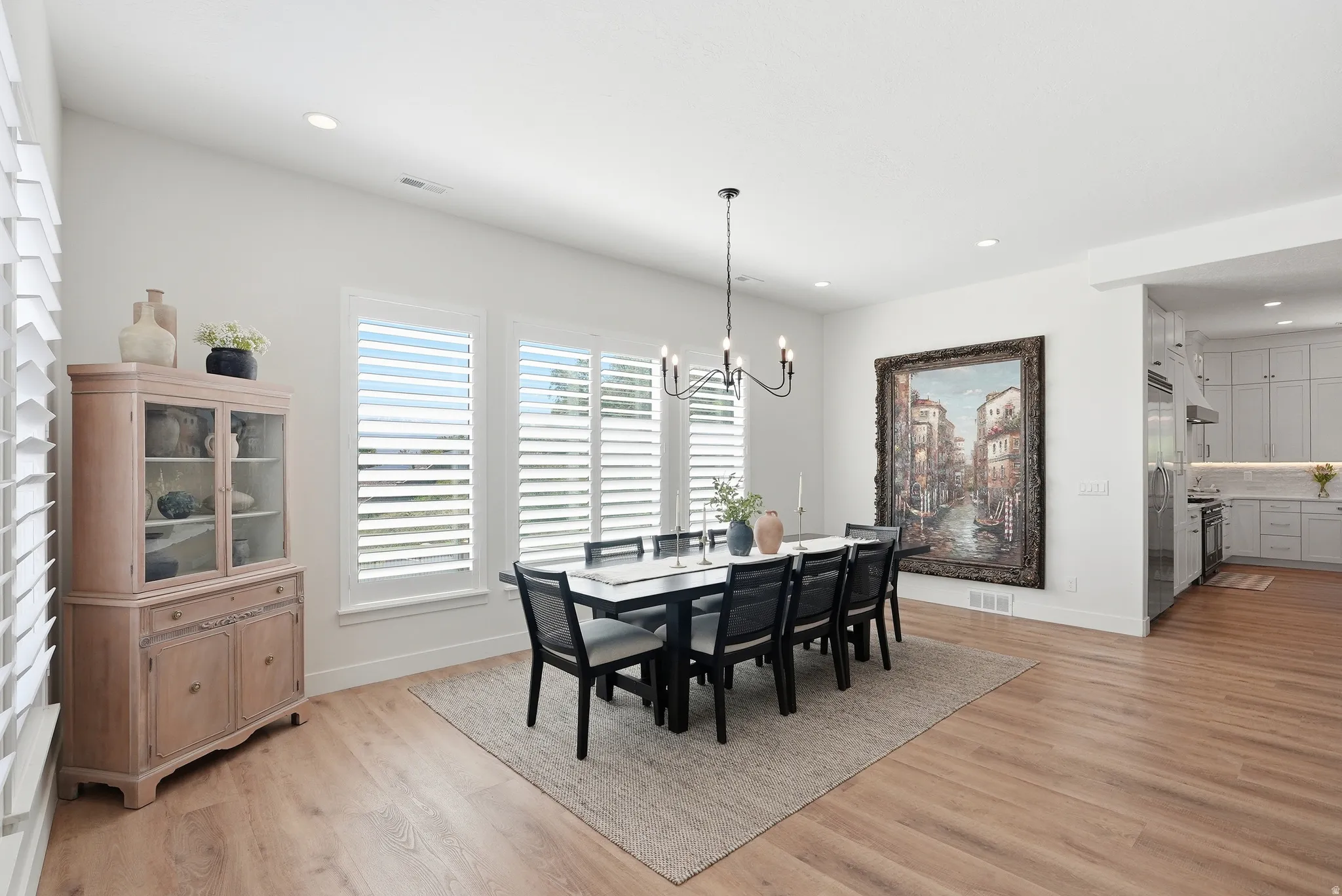 Dining area featuring LVP flooring and recessed lighting