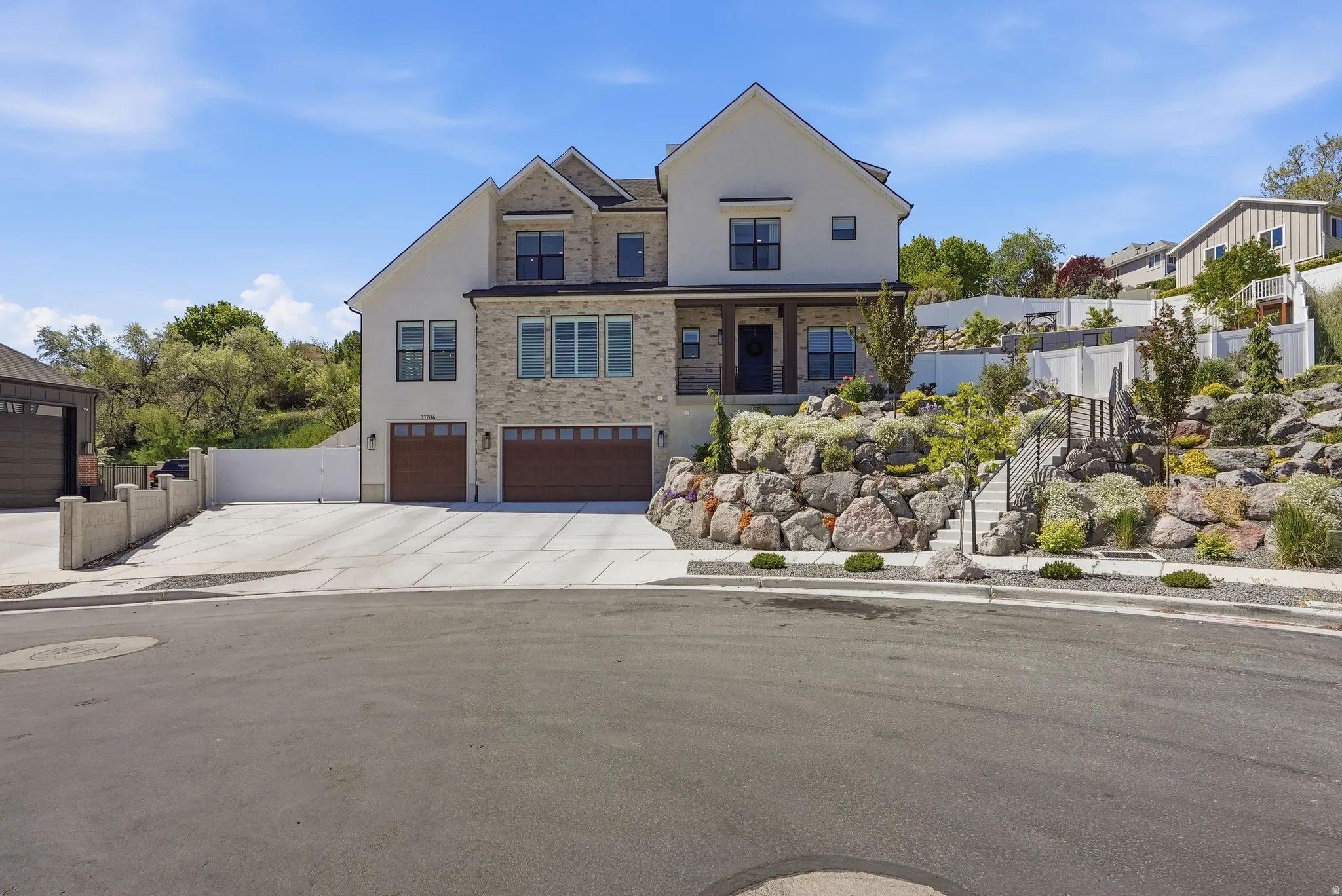 Stately two-story residence featuring a stone and stucco exterior