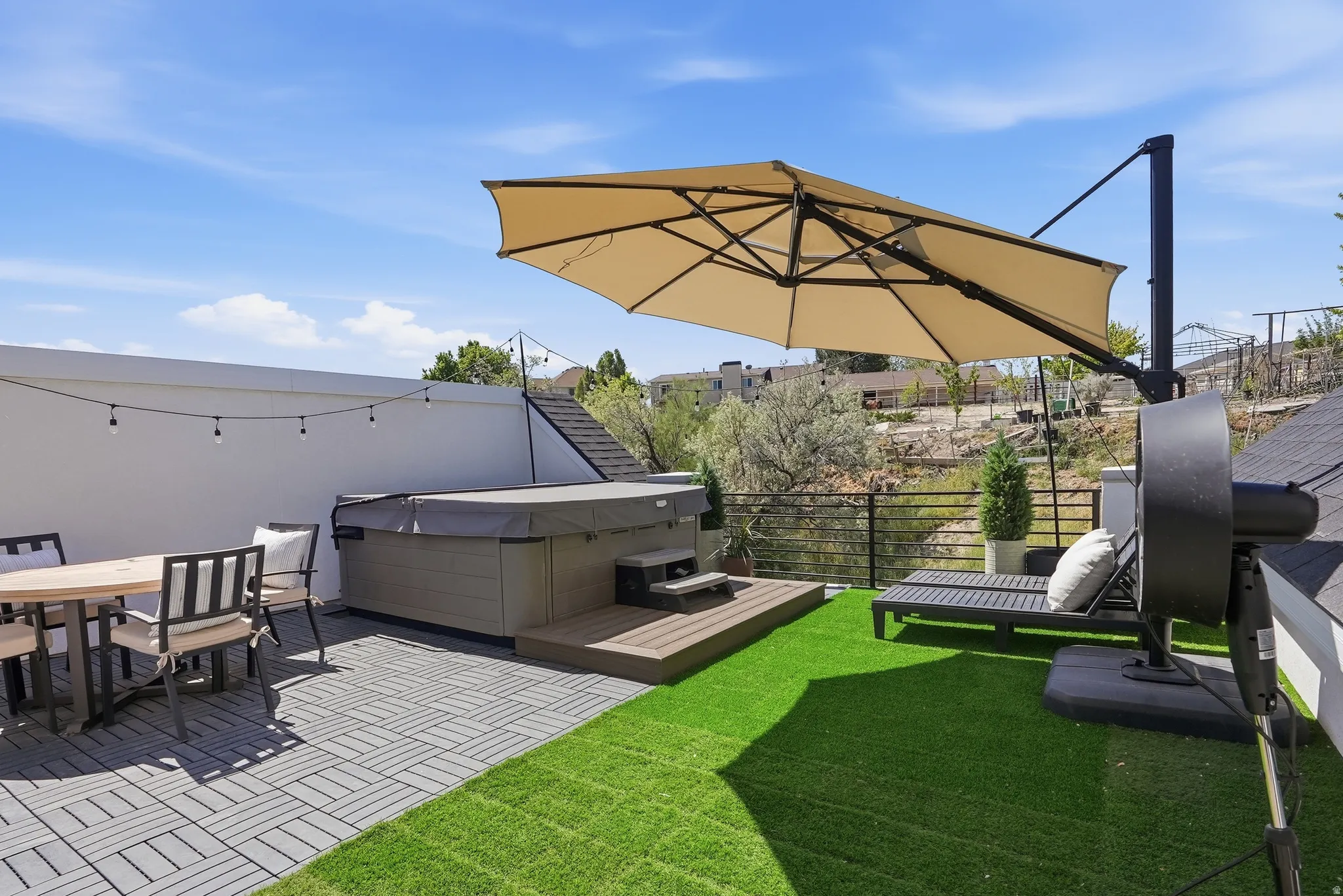 Rooftop patio featuring a built-in hot tub with Tex Step, artificial turf area,