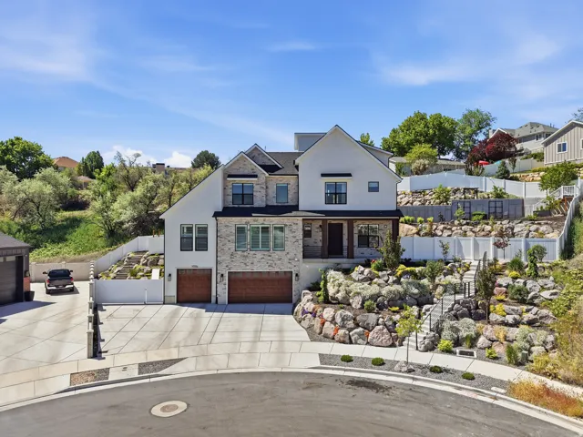 Stately two-story residence featuring a stone and stucco exterior
