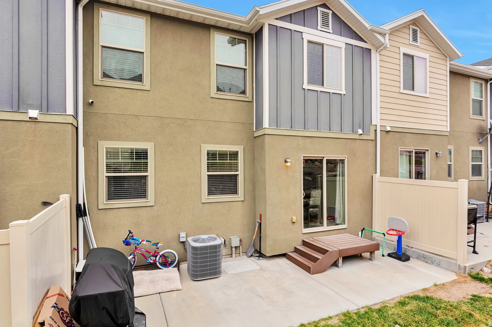 Exterior featuring a stucco facade with vertical and horizontal siding accents