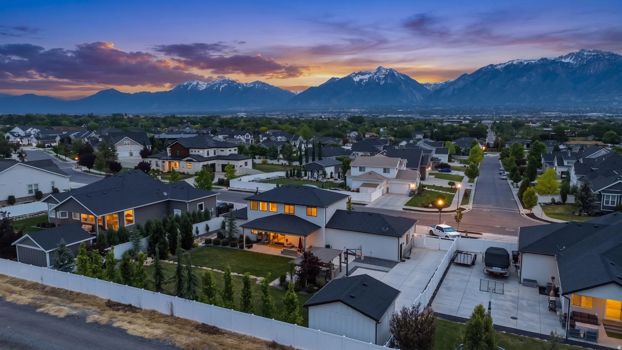 Expansive residential neighborhood featuring numerous single-story and two-story homes with dark shingle roofs
