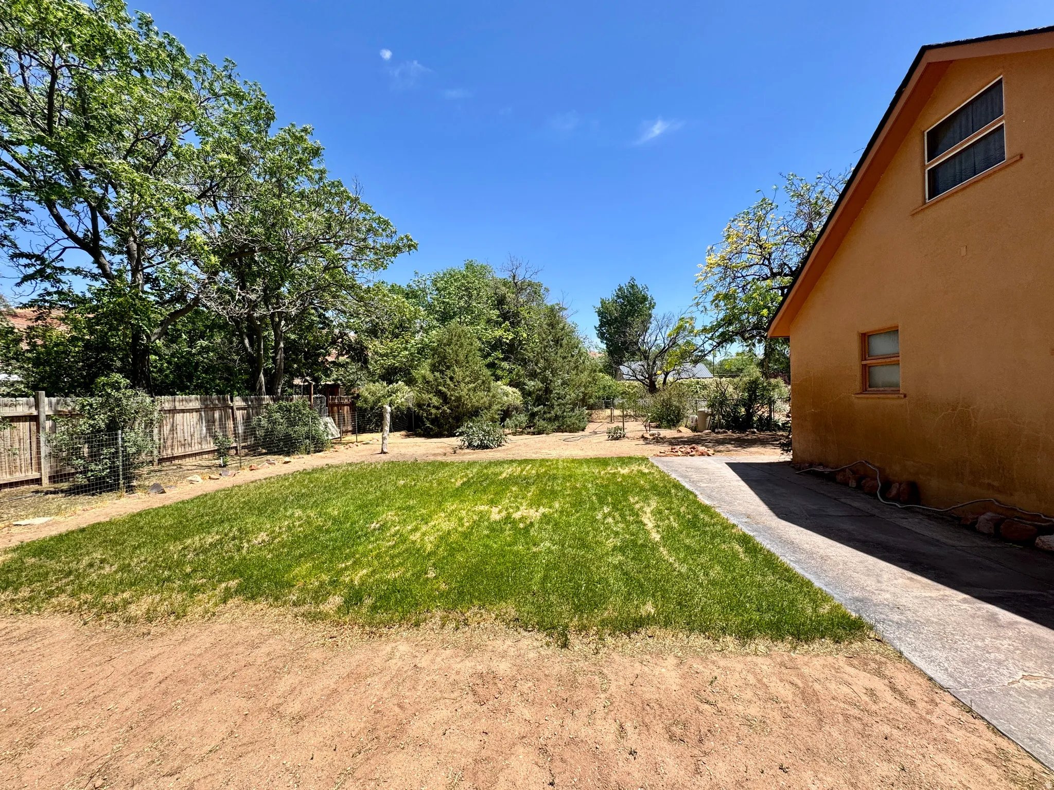 Manicured lawn area bordered by a concrete walkway