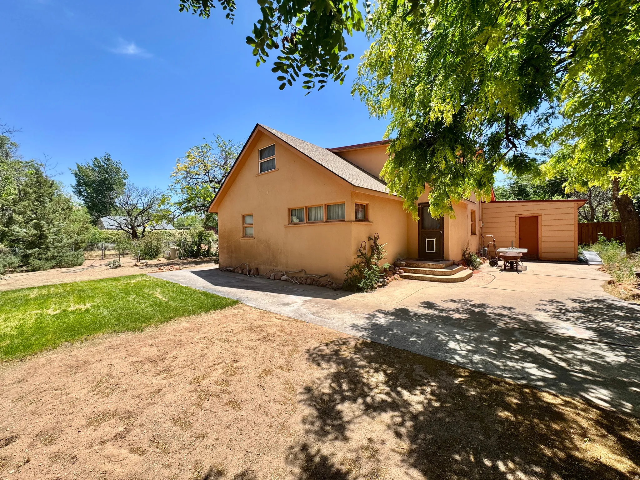 Stucco exterior with an asphalt shingle roof