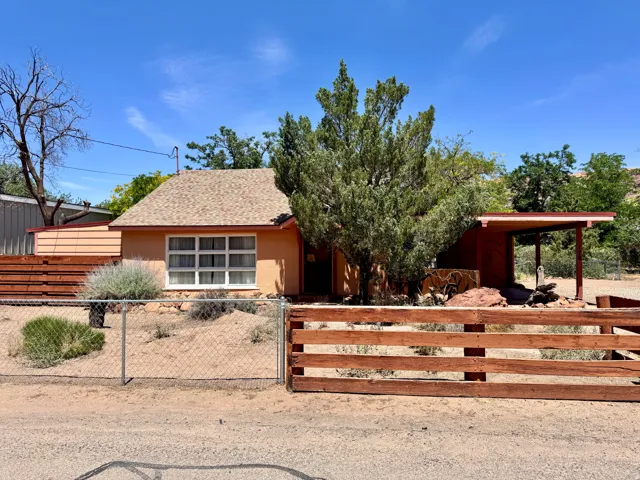 Exterior facade featuring a pitched roof, multiple windows, and a covered porch