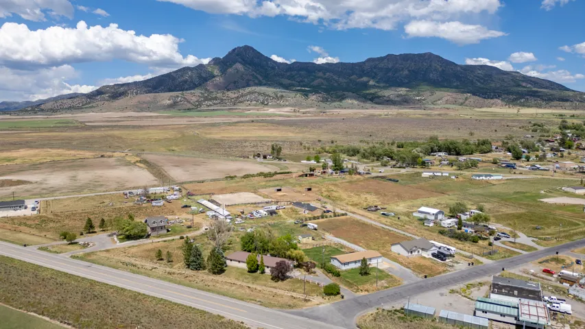 Expansive landscape featuring a mountainous backdrop under a partially cloudy sky
