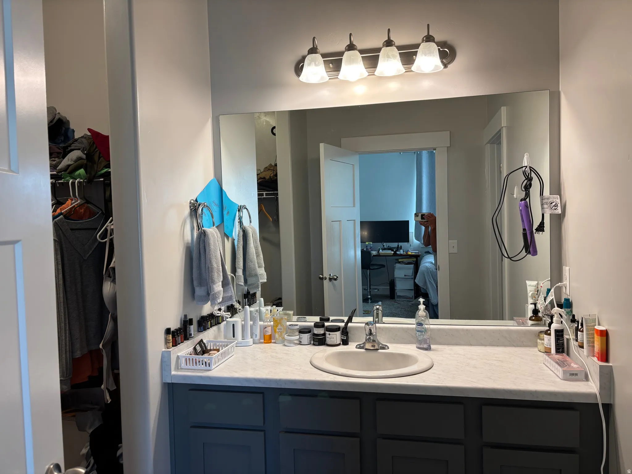 Vanity with an integrated sink, a light-toned countertop, and dark cabinetry