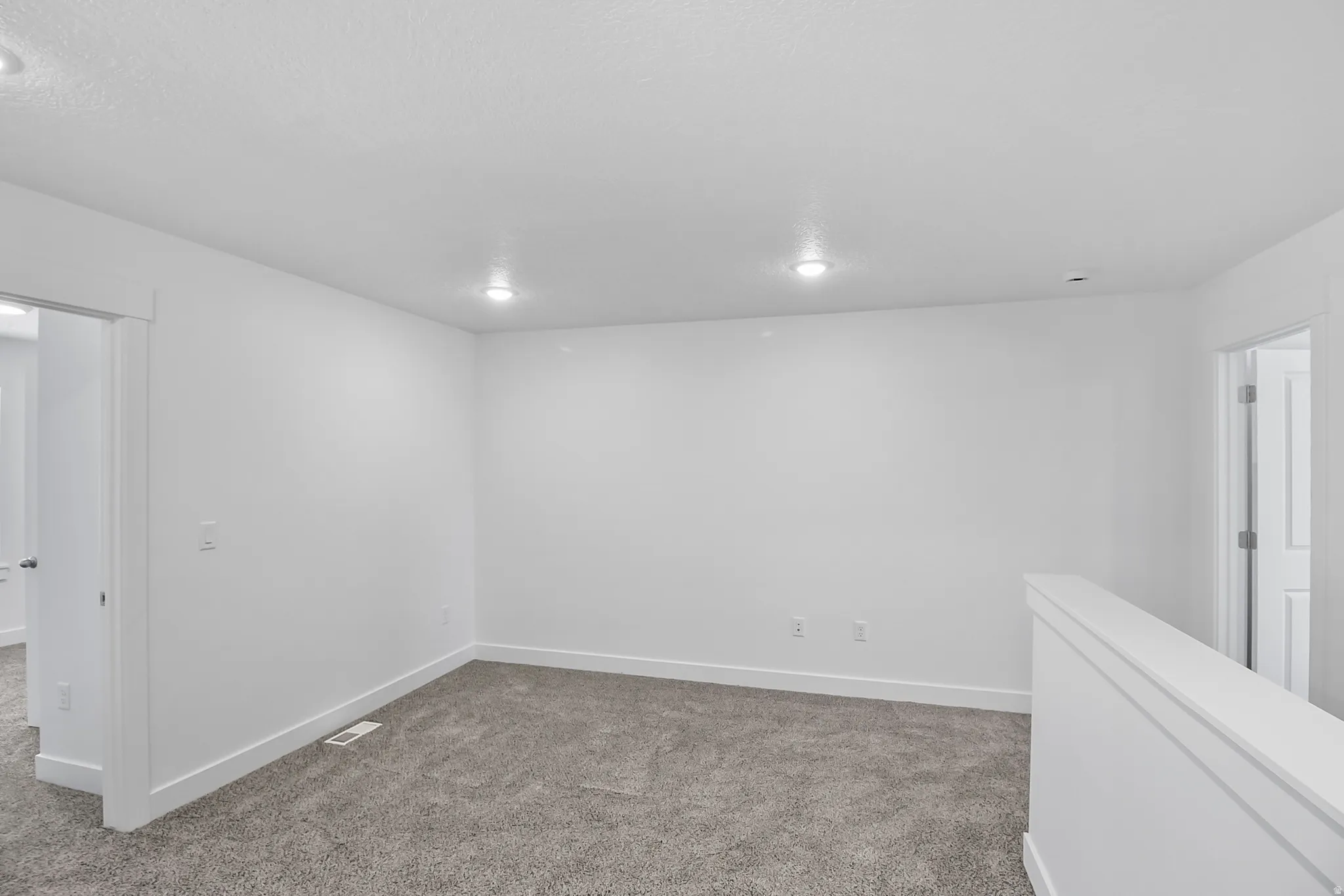 Carpeted room featuring recessed lighting, white walls, and white trim