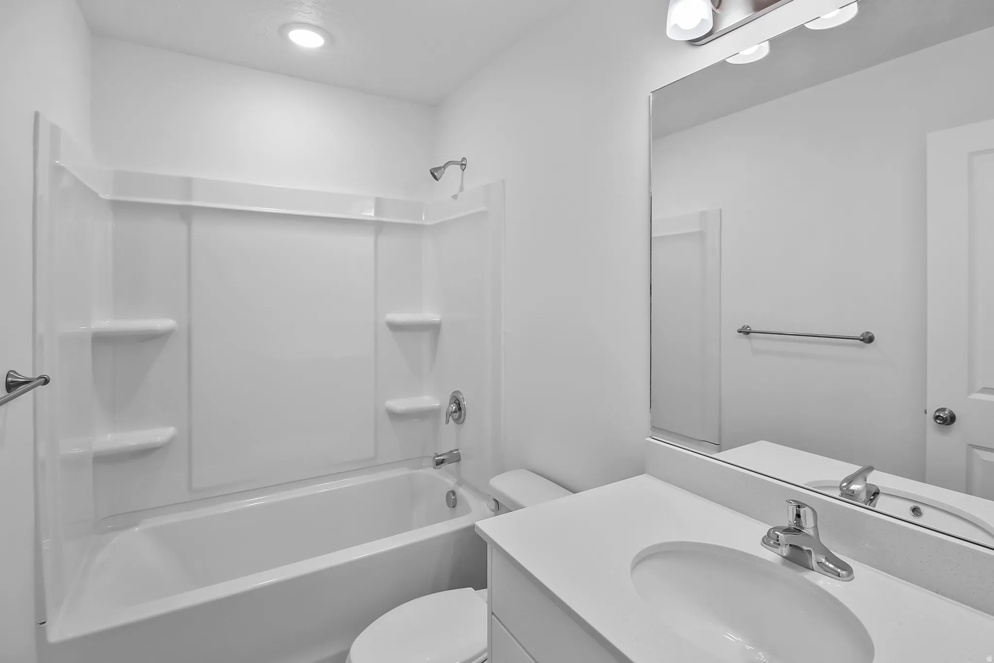 Full bathroom featuring a white tub/shower combination with integrated shelving