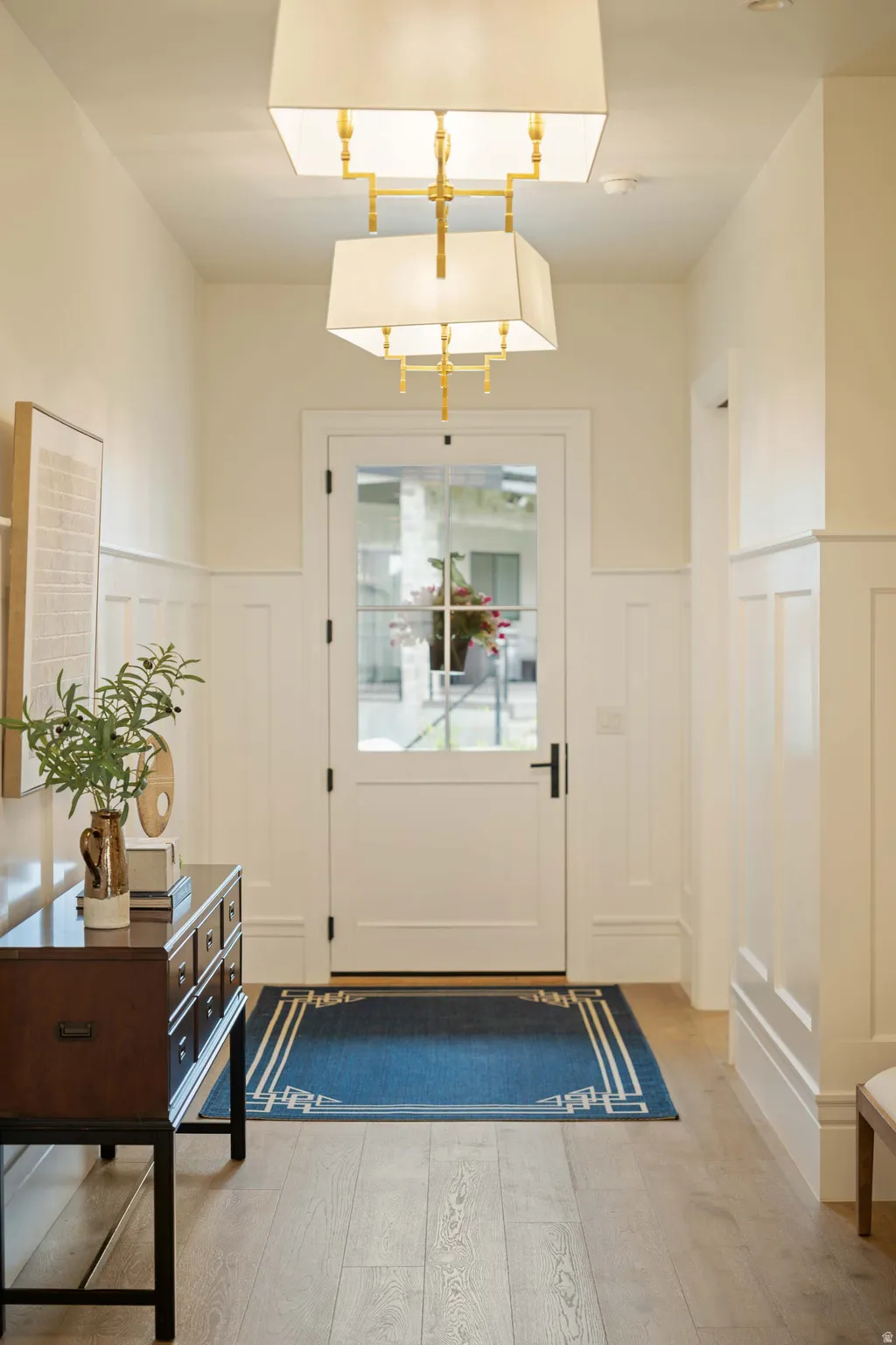 Entryway featuring wood-finish flooring and wainscoting